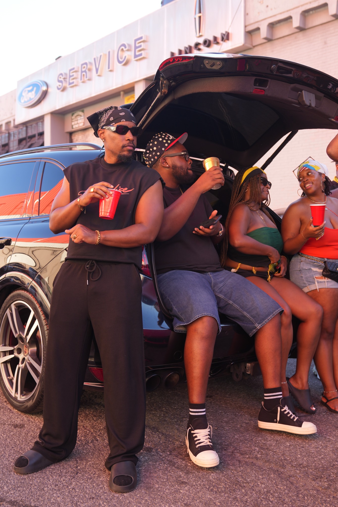 Guylaire and friends gathered beside a car during the parade
