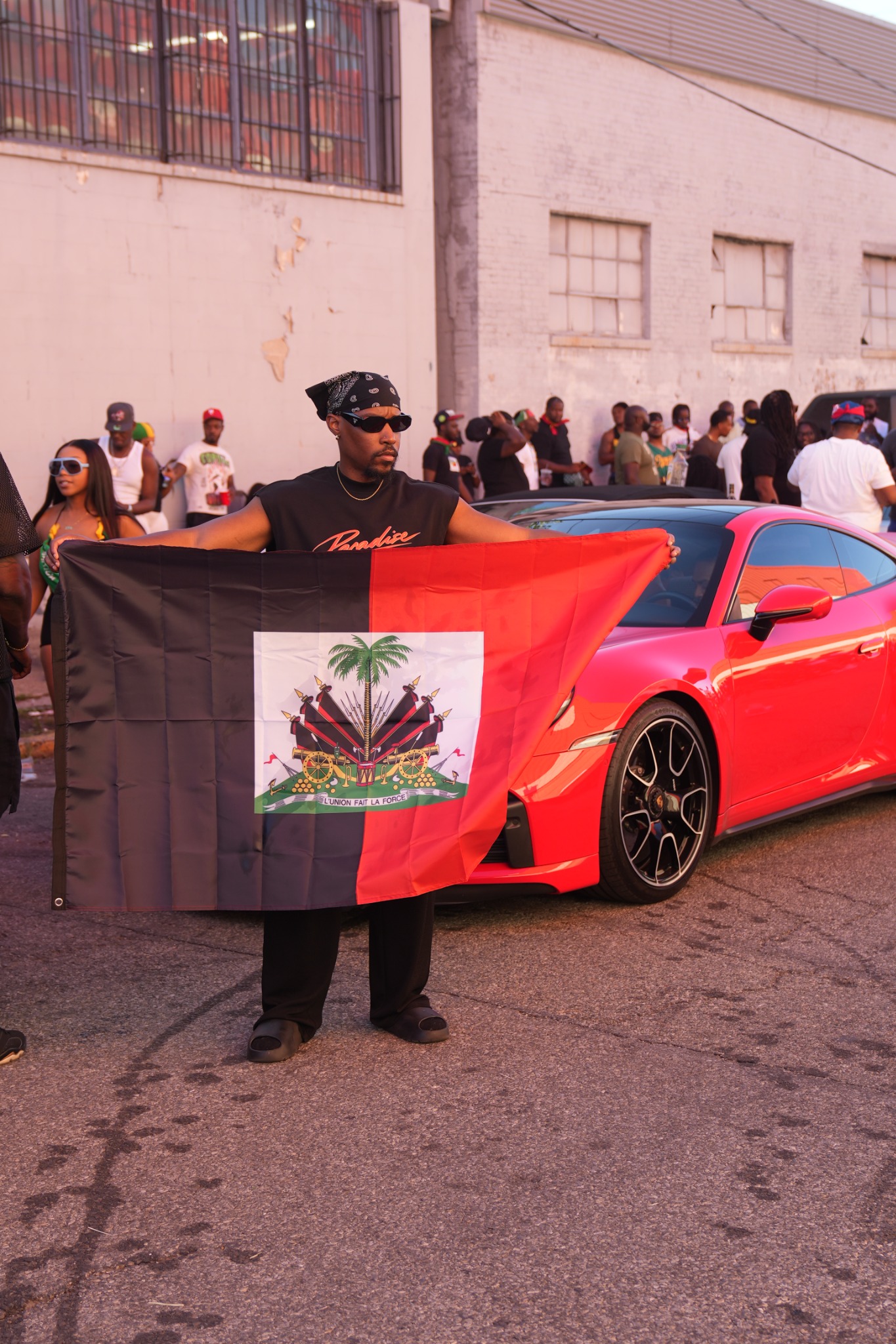 Guylaire holding the Haitian flag at the West Indian Day Parade in Brooklyn